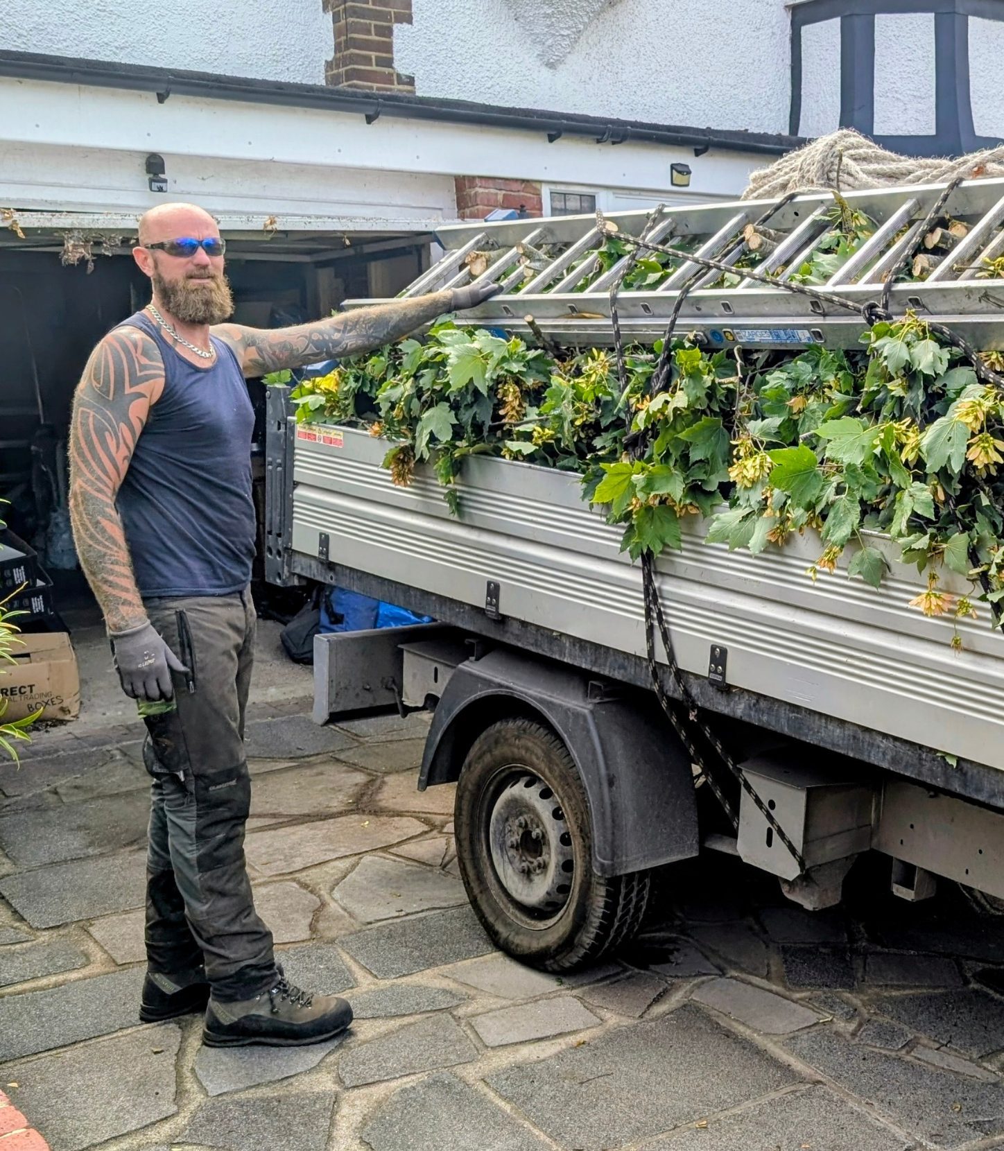 Mike loading a trailer with tree and hedge waste after a job